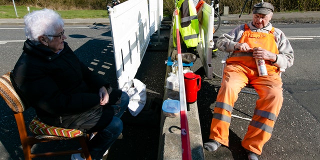Rasmussen, left, and Hansen sit at the German-Danish border crossing in Aventoft on March 27. (Frank Molter/picture-alliance/dpa/AP Images)