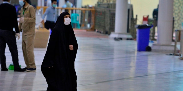 In this Monday, Feb. 24, 2020 photo, some Shiite pilgrims visit the shrine of Imam Ali in Najaf, Iraq, The Health Ministry said four new cases of coronavirus were diagnosed in the northern province of Kirkuk. It said the afflicted were members of an Iraqi family who had returned from a recent trip to Iran. Iraq announced the discovery of the first coronavirus case in the country on Monday in Najaf. Iraq had earlier closed its border with Iran to Iranian nationals but apparently Iraqis can still cross the boundary. (AP Photo/Anmar Khalil)