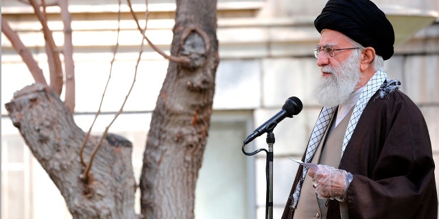 Wearing disposable gloves, Supreme Leader Ayatollah Ali Khamenei speaks during a tree planting ceremony in Tehran, Iran, Tuesday, March 3, 2020. Iran's supreme leader put the Islamic Republic on war footing Tuesday against the new coronavirus by ordering its armed forces to assist health officials in combating the outbreak that authorities say has killed 77 people. (Office of the Iranian Supreme Leader via AP)