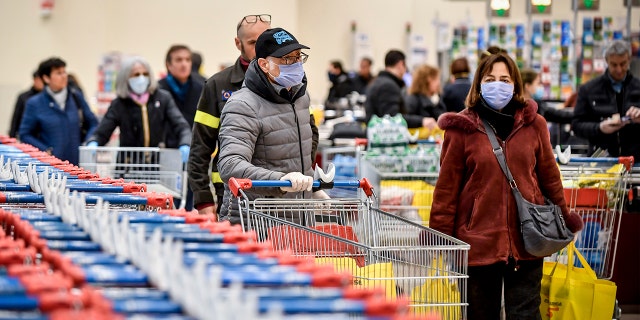 People wearing masks at a supermarket in Milan on Sunday. (Claudio Furlan/LaPresse via AP)