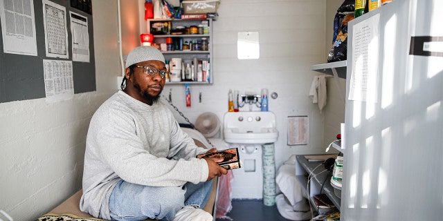 In this Thursday, Feb. 13, 2020 photo, Myon Burrell sits inside his cell at the Minnesota Correctional Facility in Stillwater. (AP Photo/John Minchillo)