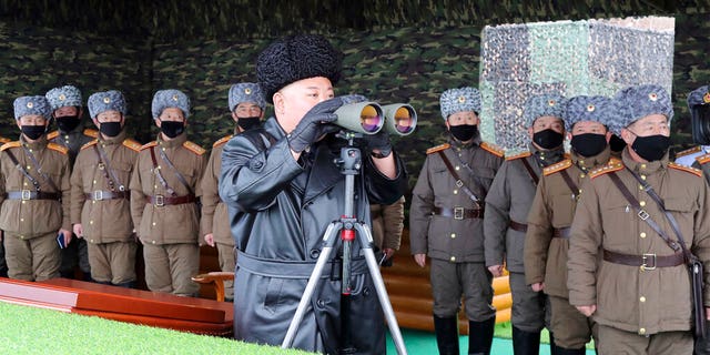 FILE - In this Friday, Feb. 28, 2020, file photo provided on Feb. 29, 2020 by the North Korean government, North Korean leader Kim Jong Un, center, inspects the military drill of units of the Korean People's Army, with soldiers shown wearing face masks. (Korean Central News Agency/Korea News Service via AP, File)