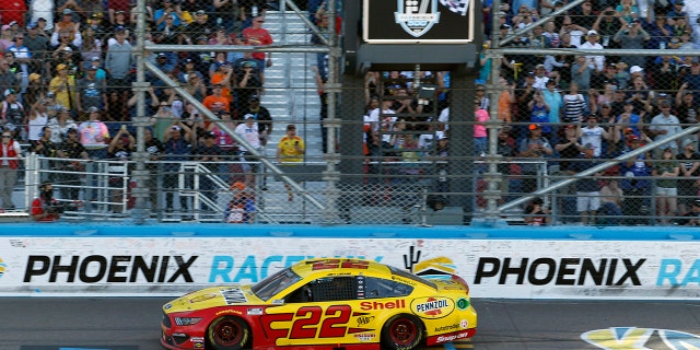 Joey Logano takes the checkered flag to win a NASCAR Cup Series auto race at Phoenix Raceway, Sunday, March 8, 2020, in Avondale, Ariz. (AP Photo/Ralph Freso)