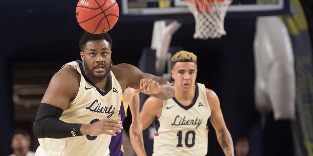 Liberty forward Myo Baxter-Bell, left, chases after ball during the first half against Lipscomb in the Atlantic Sun conference NCAA basketball championship game in Lynchburg, Va., Sunday, March 8, 2020. (AP Photo/Lee Luther Jr.)