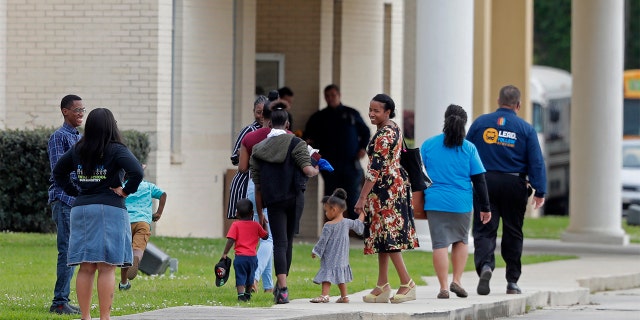 Congregants arrive at the Life Tabernacle Church in Central, La., Sunday, March 29, 2020. Pastor Tony Spell has defied a shelter-in-place order by Louisiana Gov. John Bel Edwards, due to the new coronavirus pandemic, and continues to hold church services with hundreds of congregants. (AP Photo/Gerald Herbert)