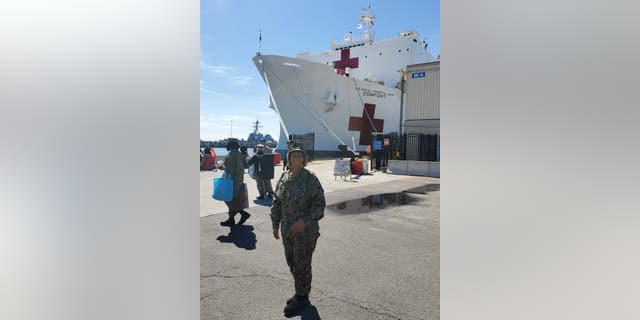 U.S. Navy Reserve Capt. Lynne Blankenbeker in front of the USNS Comfort, at Naval Station Norfolk in Virginia on March 26, 2020