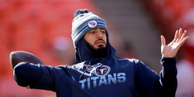 In this Jan. 19, 2020, file photo, Tennessee Titans quarterback Marcus Mariota warms up before the NFL AFC Championship football game against the Kansas City Chiefs in Kansas City, Mo. (AP Photo /Charlie Riedel, File)