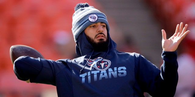 In this Jan. 19, 2020, file photo, Tennessee Titans' quarterback Marcus Mariota warms up before the NFL AFC Championship football game against the Kansas City Chiefs in Kansas City, Mo. (AP Photo/Charlie Riedel, File)