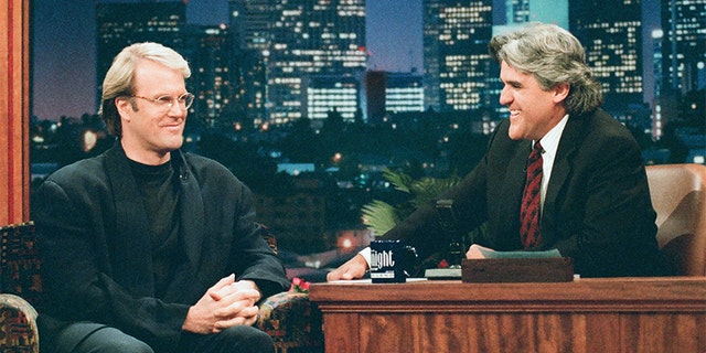 Pictured: (l-r) Musician John Tesh during an interview with host Jay Leno on June 3, 1996.