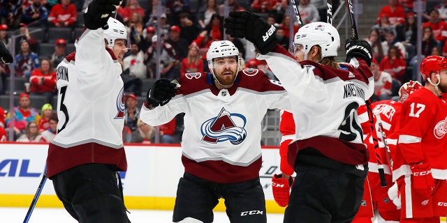 Colorado Avalanche center Vladislav Namestnikov, right, celebrates his goal with Valeri Nichushkin, left, and Martin Kaut, center, in the first period of an NHL hockey game against the Detroit Red Wings, Monday, March 2, 2020, in Detroit. (AP Photo/Paul Sancya)