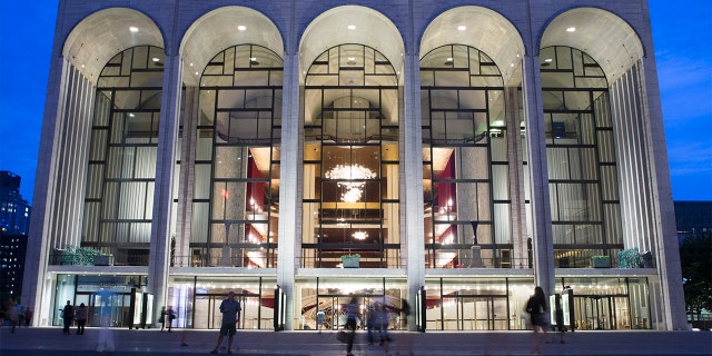 COVID-19 Booster Mandates Gain Momentum As Some Businesses, Universities Add Requirements - Fox News 2 FILE - In this Aug. 1, 2014, file photo, pedestrians make their way in front of the Metropolitan Opera house at New York's Lincoln Center. The Metropolitan Opera has instituted a vaccine mandate for employees and audience members. (AP Poto/John Minchillo, File)