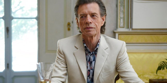 This image released by Sony Pictures Classics shows Mick Jagger in a scene from the film, "The Burnt Orange Heresy." Jagger plays a devilish art collector who cunningly convinces an art journalist to use a rare interview with a reclusive artist as an opportunity to steal one of his paintings. It’s Jagger’s first film since 2001’s “The Man From Elysian Fields.” (Jose Haro/Sony Pictures Classics via AP)