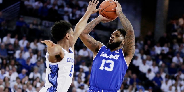 Seton Hall's Myles Powell (13) shoots against Creighton's Ty-Shon Alexander (5) during the first half of an NCAA college basketball game in Omaha, Neb., Saturday, March 7, 2020. (AP)