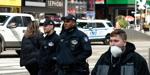 NYPD officers walk near Times Square following the outbreak of coronavirus disease (COVID-19), in New York City, U.S., March 18, 2020. 