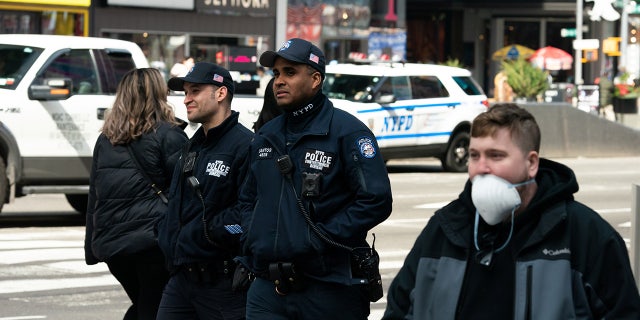NYPD officers walk near Times Square following the outbreak of coronavirus disease (COVID-19), in New York City, U.S., March 18, 2020.