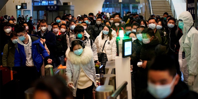 People wearing face masks arrive at a railway station in Wuhan on the first day of inbound train services resumed following the novel coronavirus disease (COVID-19) outbreak, in Wuhan of Hubei province, the epicentre of China's coronavirus outbreak, March 28, 2020. 