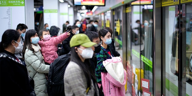People wearing face masks wait for a subway train on the first day the city's subway services resumed following the novel coronavirus disease (COVID-19) outbreak, in Wuhan of Hubei province, on March 28, 2020.  REUTERS/Aly Song 