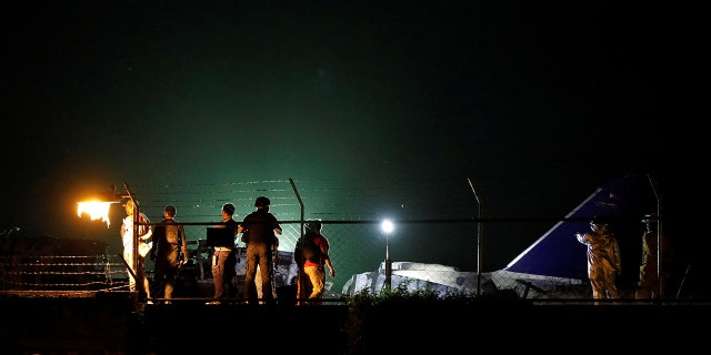 Debris of the Lion Air medical evacuation plane, that exploded during takeoff, is seen on the runway of Manila International Airport.