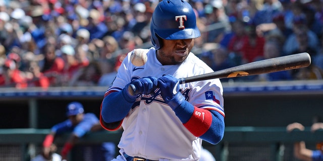 Texas Rangers outfielder Willie Calhoun reacts as he is hit in the face with a pitch during a spring training game in Surprise, Ariz., against the Los Angeles Dodgers. (Joe Camporeale-USA TODAY Sports)