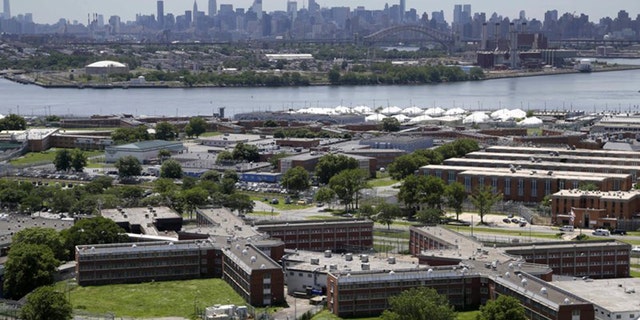 The Rikers Island jail complex in New York with the Manhattan skyline in the background.
