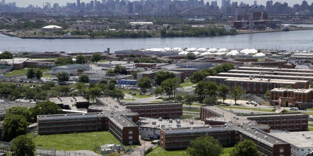 The Rikers Island jail complex stands in New York with the Manhattan skyline in the background.