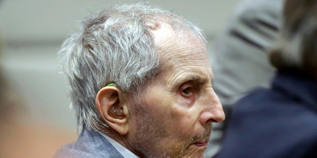 FILE - In this Tuesday, March 10, 2020, file photo, real estate heir Robert Durst listens to his defense attorney give their opening statement during his murder trial in Los Angeles. Durst's trail has been delayed for three weeks over fears of the transmission of coronavirus and will stand adjourned until April 6. (AP Photo/Alex Gallardo, Pool, File)