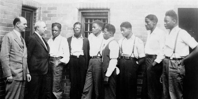 Just after he asked the Governor of Alabama to pardon the nine youths held in the Scottsboro case, Samuel Leibowitz, New York attorney, conferred with seven of the defendants, May 1, 1935, at the Scottsboro jail. Left to right are: Deputy Sheriff Charles McComb, Leibowitz, and the defendants, Roy Wright, Olen Montgomery, Ozie Powell, Willie Robertson, Eugene Williams, Charlie Weems, and Andy Wright. The youths were charged with an attack on two white women on March 25, 1931. (AP Photo)