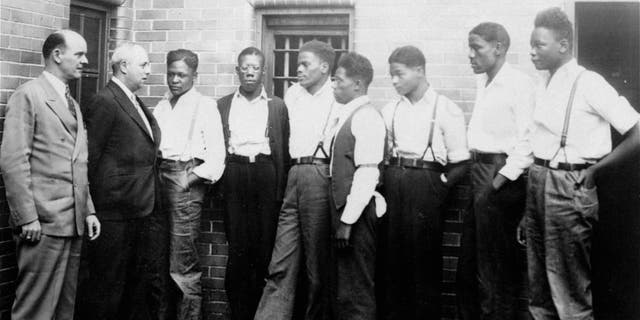 Just after he asked the Governor of Alabama to pardon the nine youths held in the Scottsboro case, Samuel Leibowitz, New York attorney, conferred with seven of the defendants, May 1, 1935, at the Scottsboro jail. Left to right are: Deputy Sheriff Charles McComb, Leibowitz, and the defendants, Roy Wright, Olen Montgomery, Ozie Powell, Willie Robertson, Eugene Williams, Charlie Weems, and Andy Wright. The youths were charged with an attack on two white women on March 25, 1931. (AP Photo)