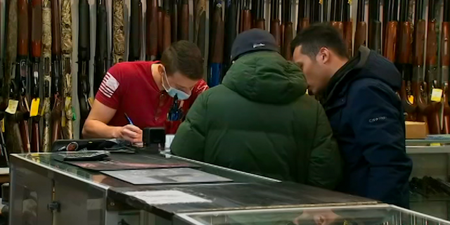 Coronavirus pandemic triggers spike in gun sales 2 Individual completes the necessary paperwork to purchase a firearm.