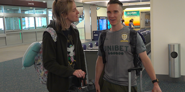 Jack Howarth (right) and his wife, Lucy, arrive at Orlando International Airport for their two-year wedding anniversary (Robert Sherman, Fox News)