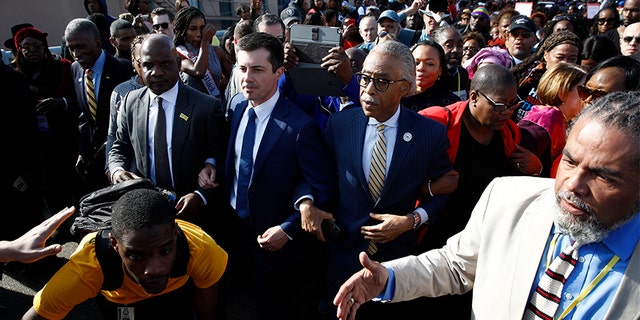 Democratic presidential candidate and former South Bend, Ind. Mayor Pete Buttigieg and the Rev. Al Sharpton, walk across the Edmund Pettus Bridge in Selma, Ala., Sunday, March 1, 2020, to commemorate the 55th anniversary of "Bloody Sunday," when white police attacked black marchers in Selma. (AP Photo/Patrick Semansky)