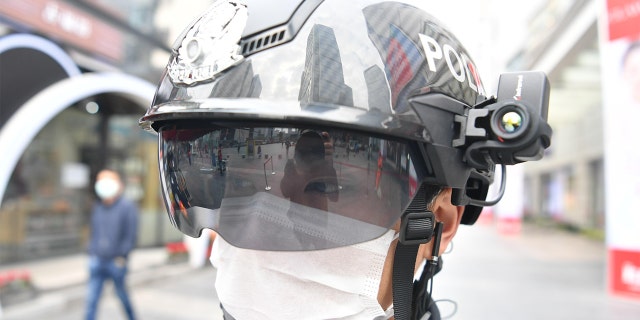 A police officer wearing a smart helmet stands guard at Chunxi Road on March 7, 2020 in Chengdu, Sichuan Province of China.