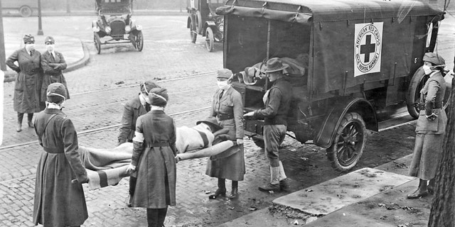 Members of the American Red Cross remove Spanish influenza victims from a house at Etzel and Page avenues in 1918. Selma Esther Ryan and her sister Esther died from the coronavirus and Spanish Flu pandemics, 102 years apart.