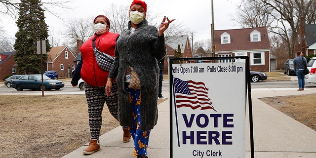 Voters arrive with masks in light of the coronavirus COVID-19 health concern at Warren E. Bow Elementary School in Detroit, Tuesday, March 10, 2020. (Associated Press)