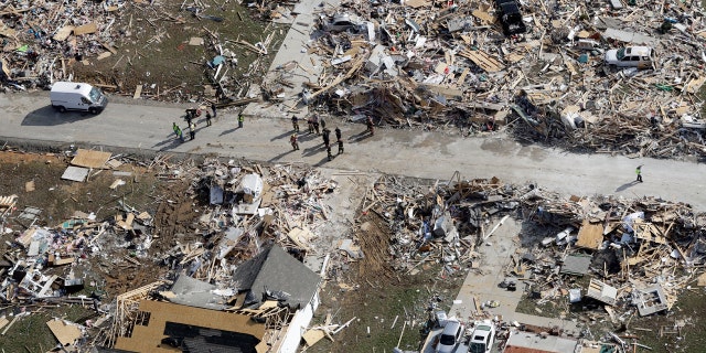 Emergency personnel work among destroyed homes Tuesday, March 3, 2020, near Cookeville, Tenn. AP Photo/Mark Humphrey