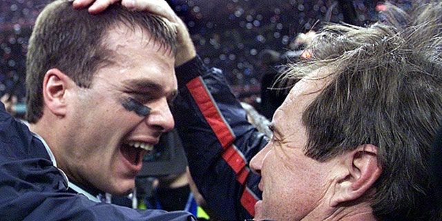 NEW ORLEANS, UNITED STATES:  New England Patriots' quarterback Tom Brady celebrates with head coach Bill Belichick (R) after their win over the St. Louis Rams 03 February, 2002 in Super Bowl XXXVI in New Orleans, Louisiana. The Patriots defeated the Rams 20-17 for the NFL championship. AFP PHOTO/Jeff HAYNES (Photo credit should read JEFF HAYNES/AFP via Getty Images)