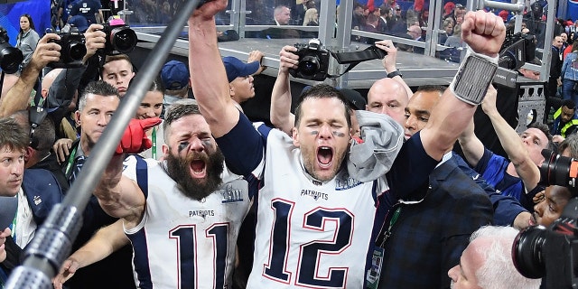 Julian Edelman (11) of the New England Patriots and teammate Tom Brady (12) celebrate at the end of Super Bowl LIII at Mercedes-Benz Stadium on Feb. 3, 2019, in Atlanta, Ga. The New England Patriots defeated the Los Angeles Rams 13-3. (Harry How/Getty Images)