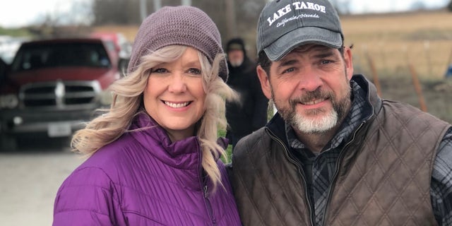 Troy Brewer, pastor of OpenDoor Church in Burleson, , with his wife, Leanna, as they host drive-thru prayer at their church.