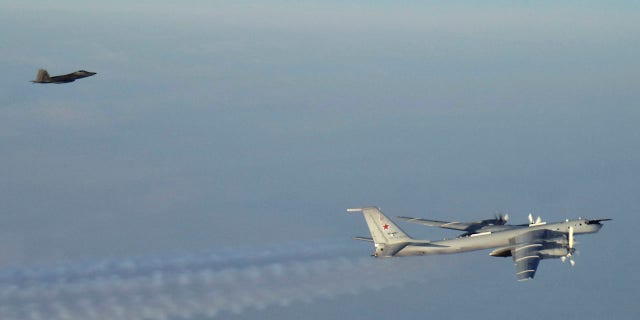 A Russian plane, pictured right, came as close as 50 miles to the Alaskan coast, according to officials. (North American Aerospace Defense Command via AP)