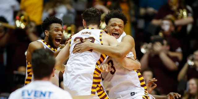 Winthrop guard Micheal Anumba, right, hugs guard Kyle Zunic as they celebrate after winning the Big South tournament championship over Hampton in an NCAA college basketball game in Rock Hill, S.C., Sunday, March 8, 2020. (AP Photo/Nell Redmond)