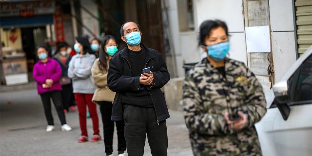 <br>
​​​​​​Customers stand in a spaced line as they wait to buy pork in Wuhan, China, on March 18, 2020. (Associated Press)