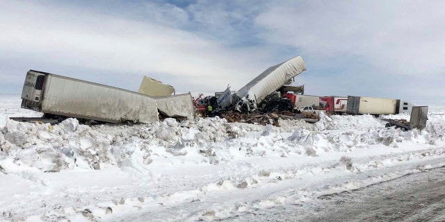 Wrecked tractor-trailers remain on the scene Monday, March 2, 2020, following Sunday's accident, on Interstate 80 in south central Wyoming.