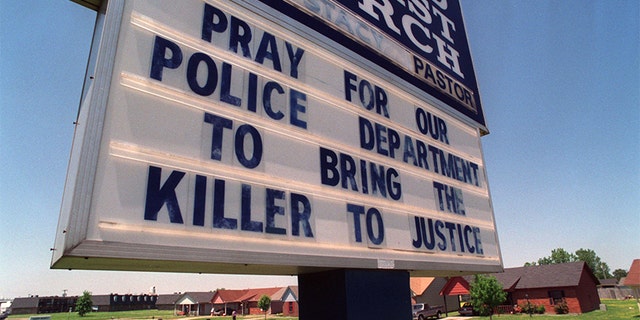 Photo circa 1993: A sign of police support hangs at Second Baptist Church on E. Barton Street in West Memphis Friday afternoon. The church is down the street from the wooded area where the bodies of the three boys were found.