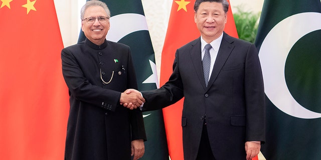 Xi shook hands with Alvi on Tuesday before a meeting at the Great Hall of the People in Beijing despite clear health warnings to avoid such physical contact amid the coronavirus outbreak. (Zhai Jianlan/Xinhua via AP)