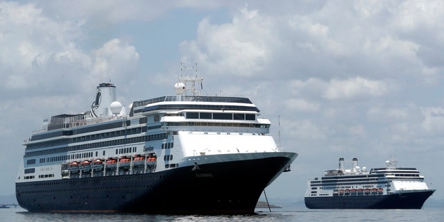 The Zaandam cruise ship, left, and the Rotterdam, seen here outside of Panama last week, are currently waiting to disembark in Florida. (AP Photo/Arnulfo Franco)