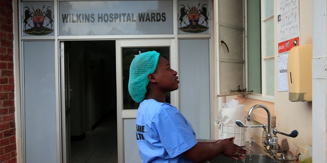 A health worker washes her hands during a demonstration of preparations for any potential coronavirus cases at a hospital in Harare, Zimbabwe, March 11, 2020. (REUTERS/Philimon Bulawayo)