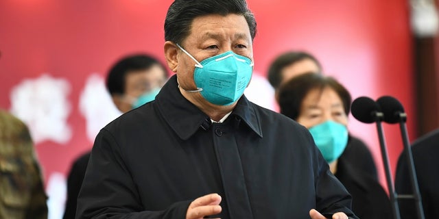 In this photo released by China's Xinhua News Agency, Chinese President Xi Jinping talks by video with patients and medical workers at the Huoshenshan Hospital in Wuhan in central China's Hubei Province earlier this month.  (Xie Huanchi/Xinhua via AP)