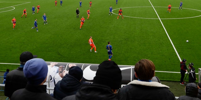 In this photo taken on Thursday, March 19, 2020, football fans watch the Belarus Championship soccer match between Energetik-BGU and Bate in Minsk, Belarus. (AP Photo/Sergei Grits)