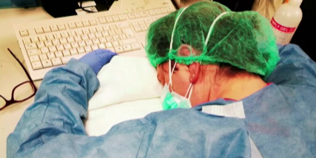 The toll of fighting the coronavirus outbreak has been captured in a daunting photo of an Italian nurse resting after hours of working non-stop