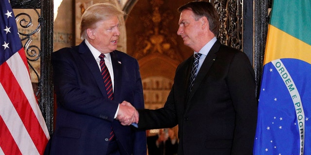 U.S. President Donald Trump shakes hands with Brazilian President Jair Bolsonaro before attending a working dinner at the Mar-a-Lago resort in Palm Beach, Florida, U.S., March 7, 2020. Picture taken March 7, 2020.